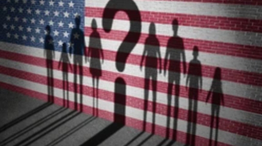 People in front of fence with American flag and question mark