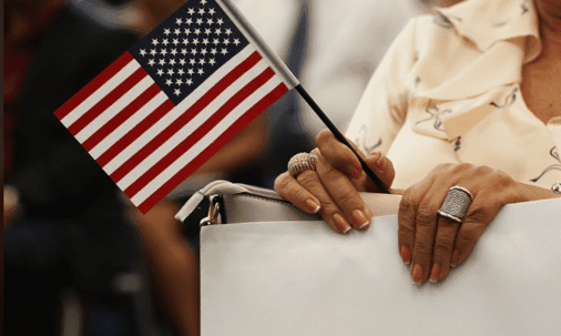 Lady holding paperwork and American flag