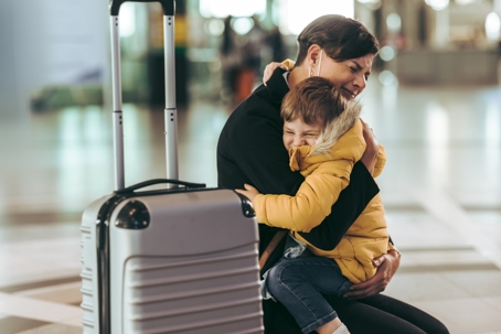emotional mother hugging her son at the airport