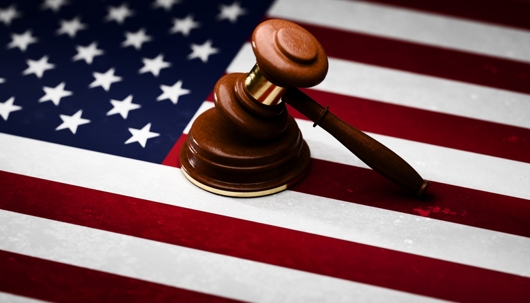 Gavel sitting on top of textured American flag stock photo