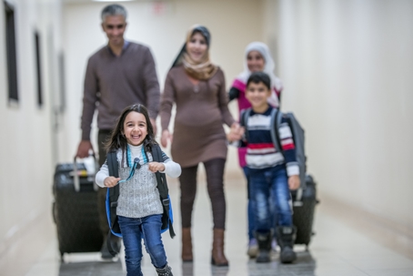 immigrant family walking in the airport