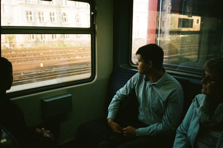 people traveling on train looking out window